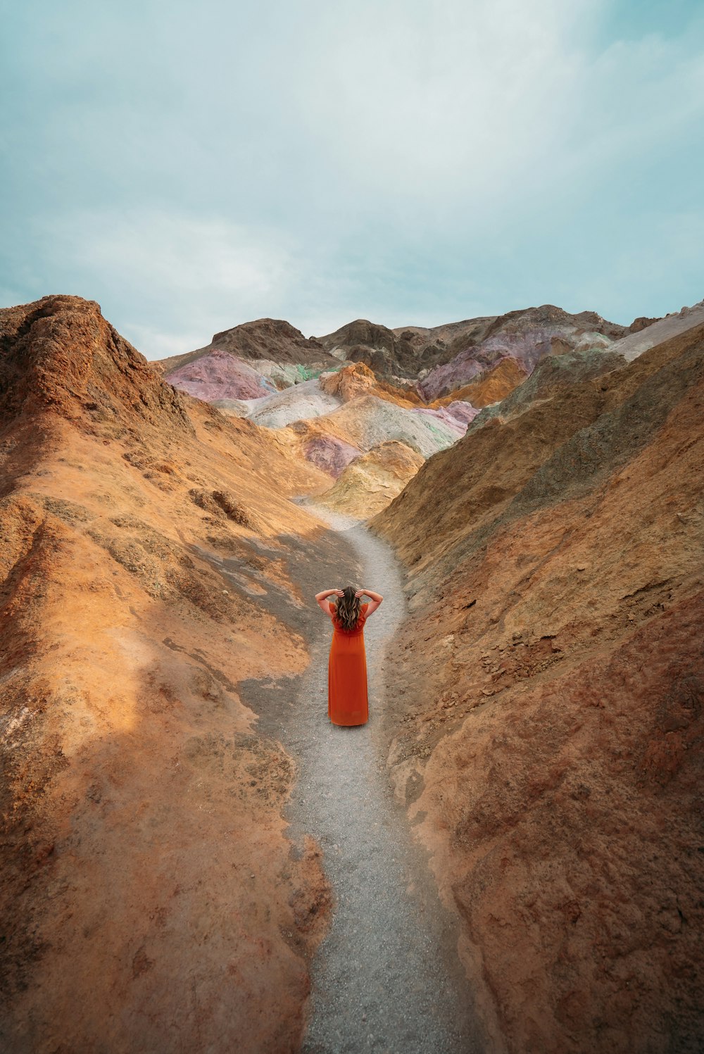 orange and white traffic cone on brown dirt road