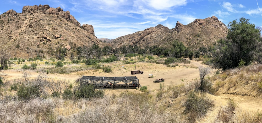 brown and black truck on brown field during daytime