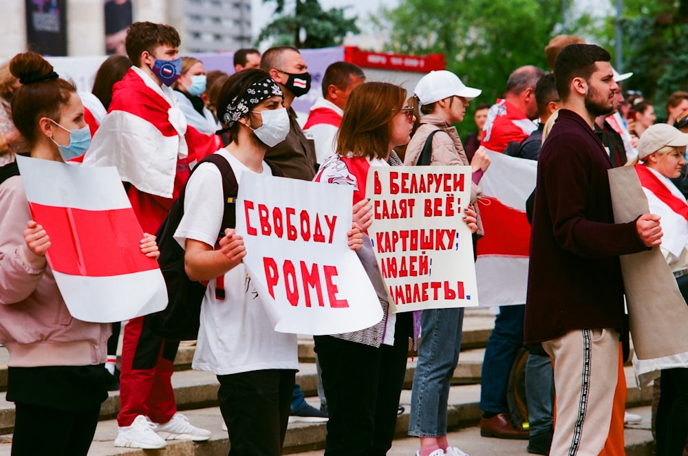 people holding white and red banner