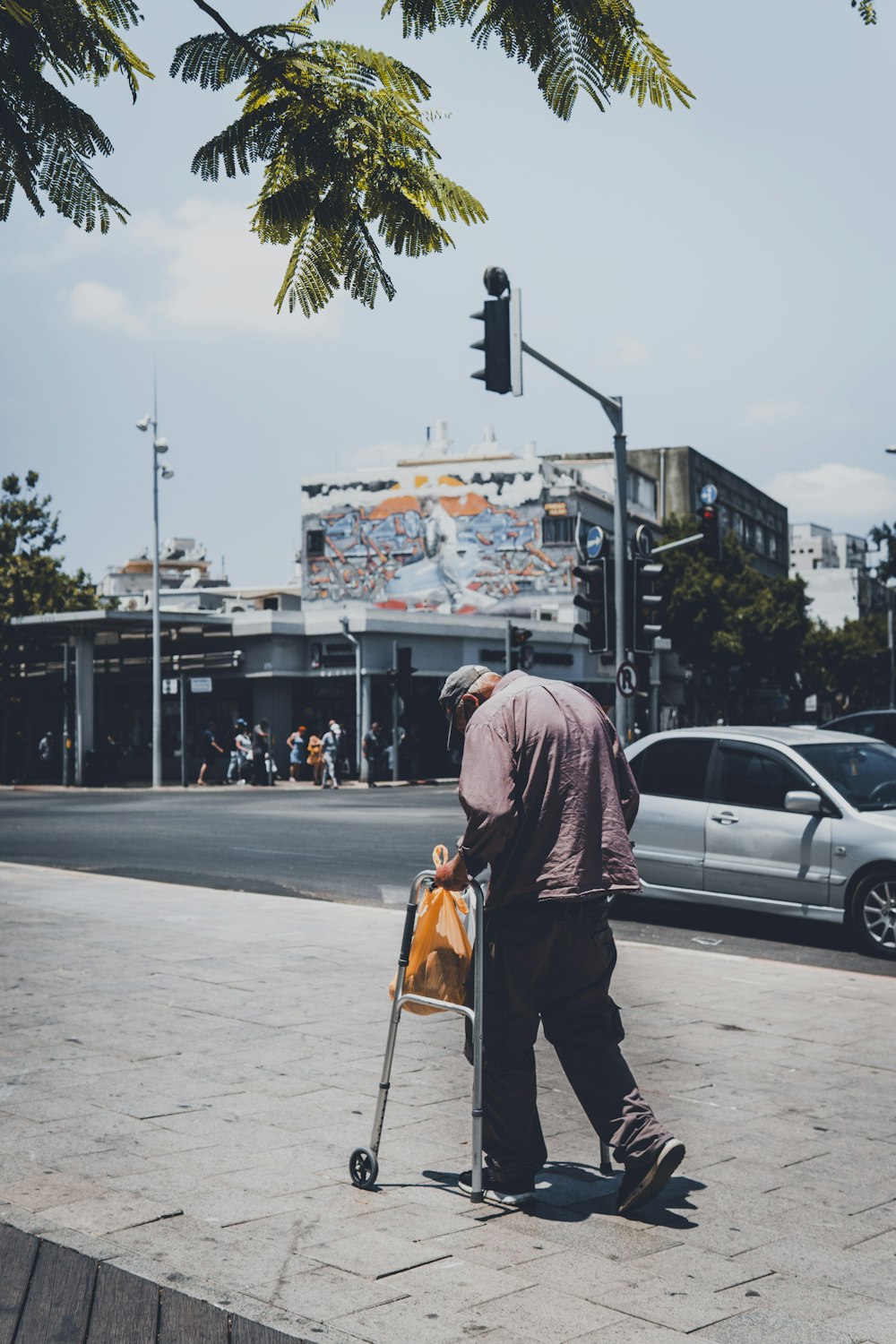 man in black jacket walking on sidewalk during daytime