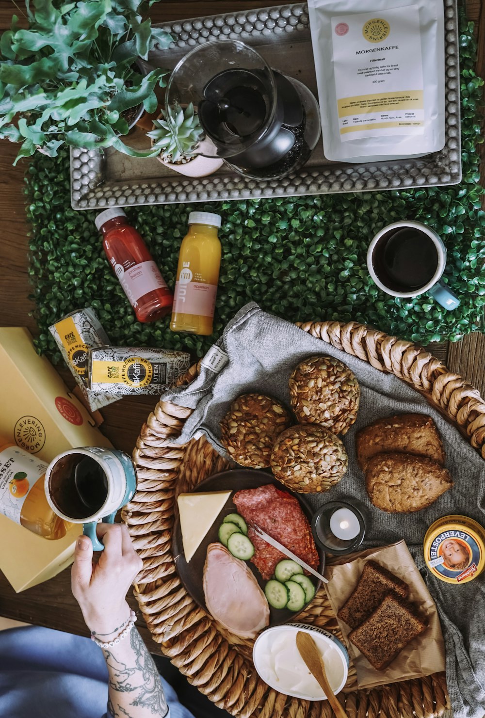 a person sitting at a table with a basket of food