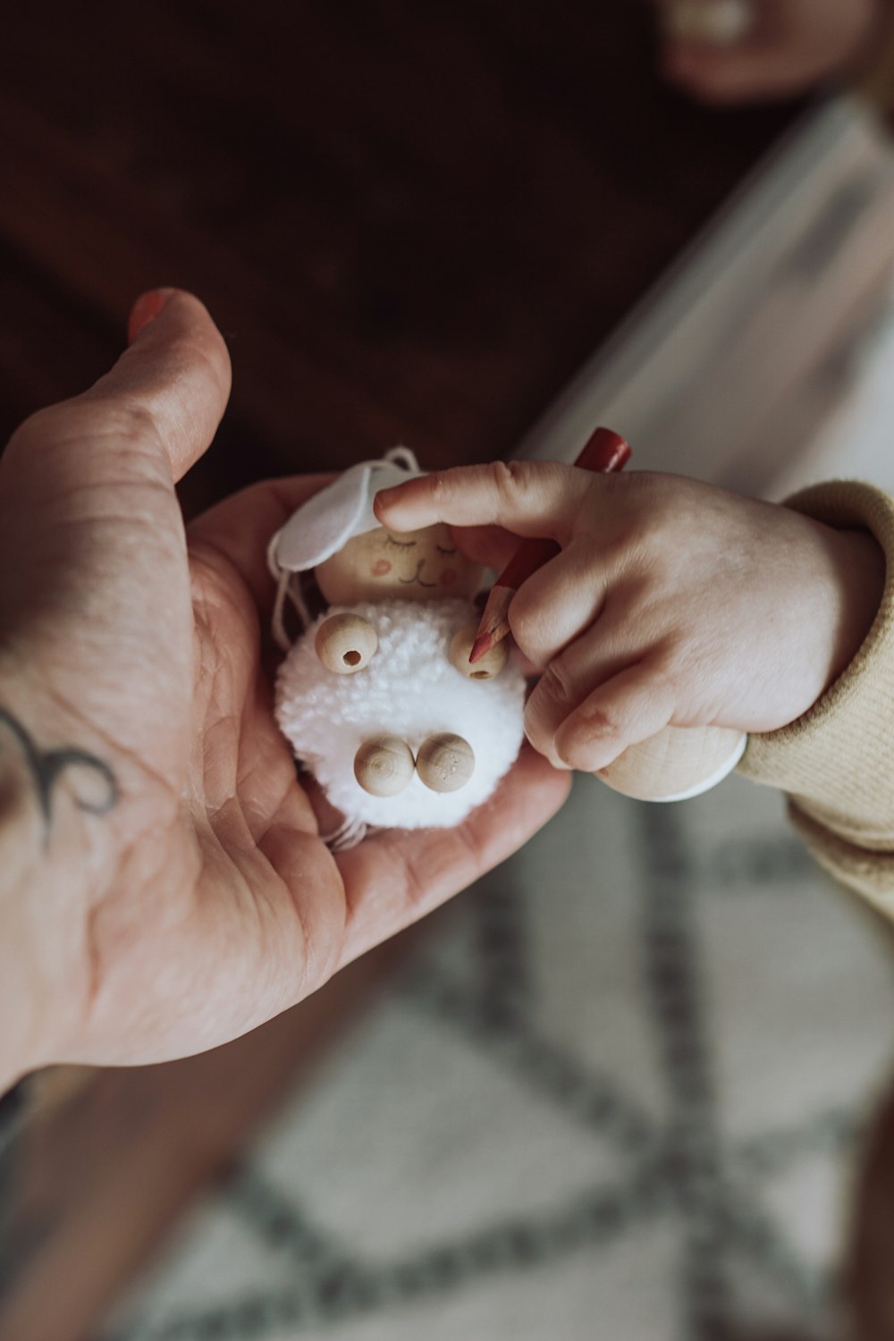 a person holding a small doll in their hands