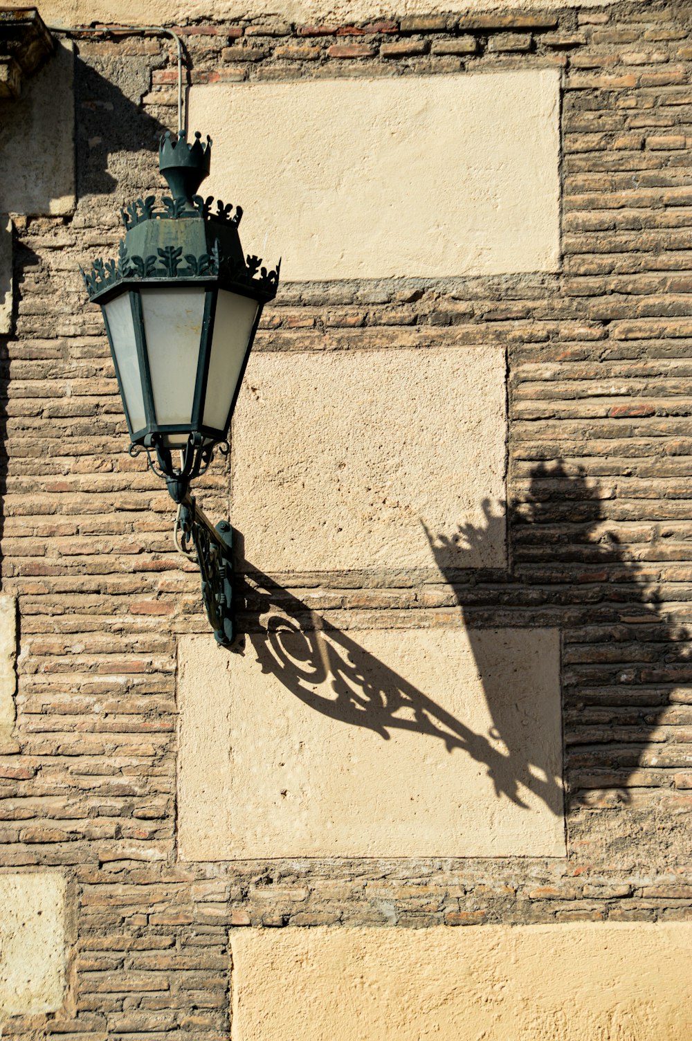 black sconce lamp on white brick wall