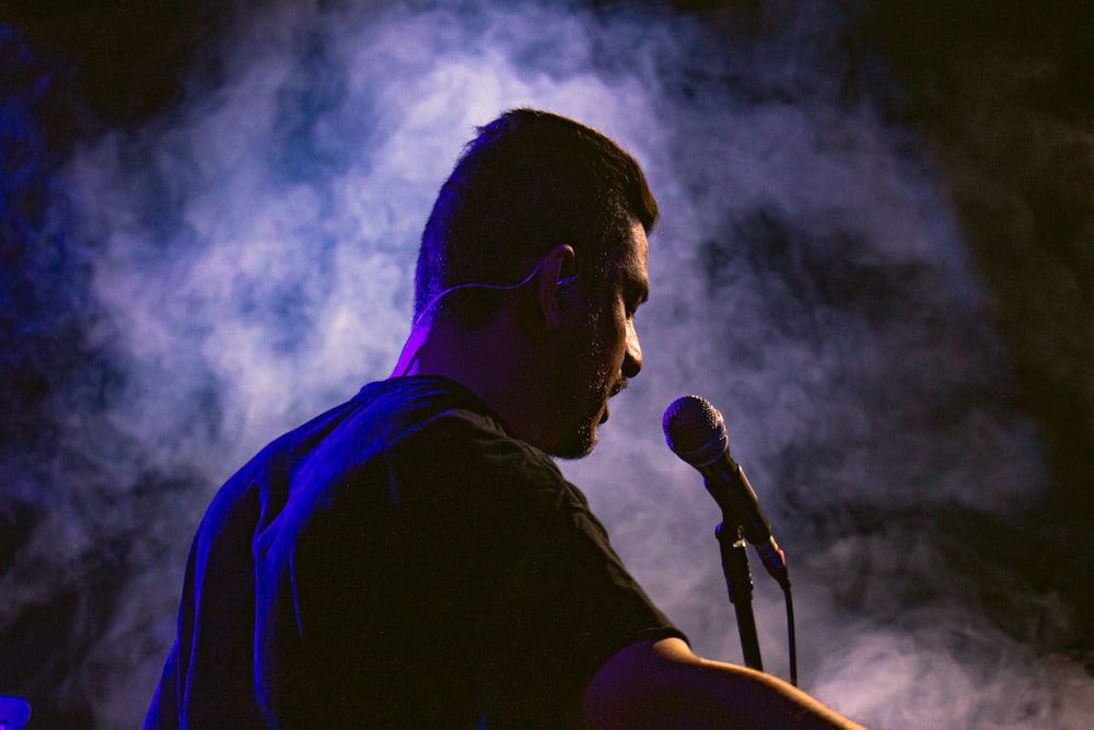 a man standing in front of a microphone