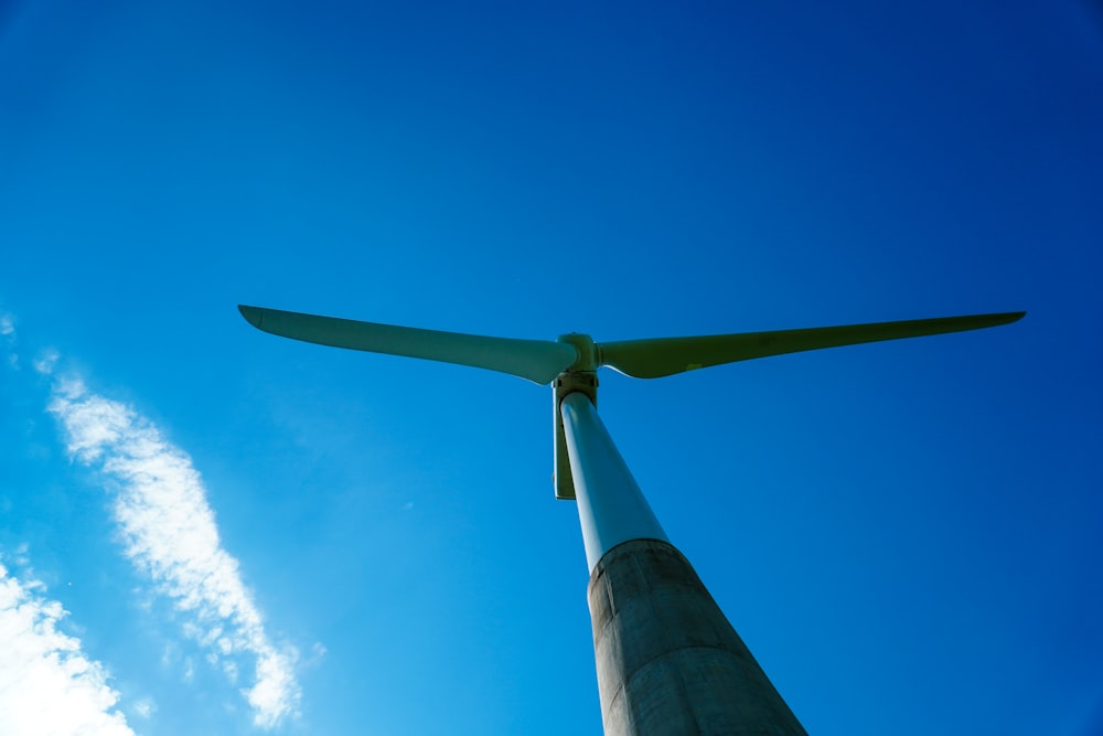 white wind turbine under blue sky during daytime