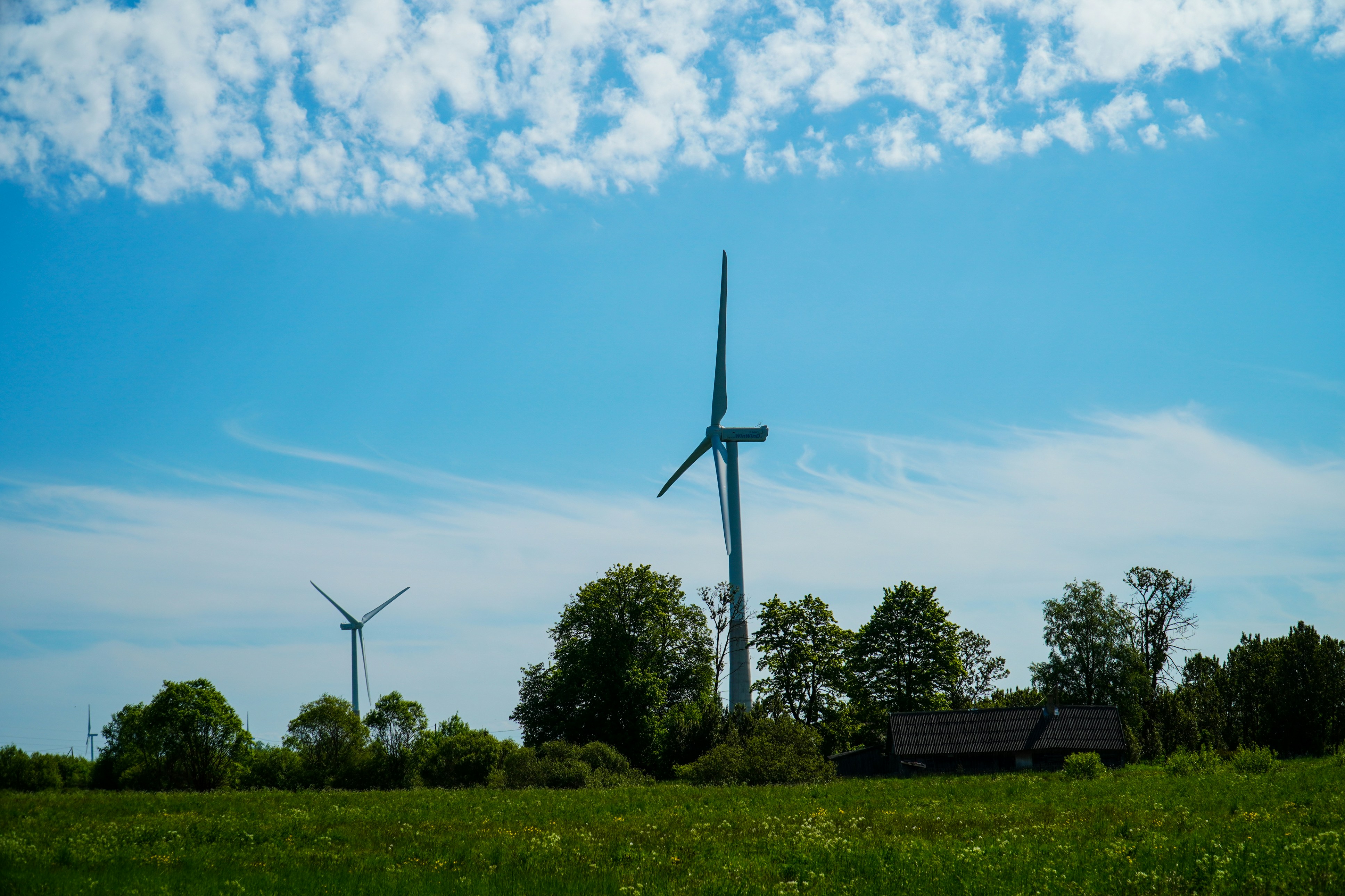 white windmill under blue sky during daytime