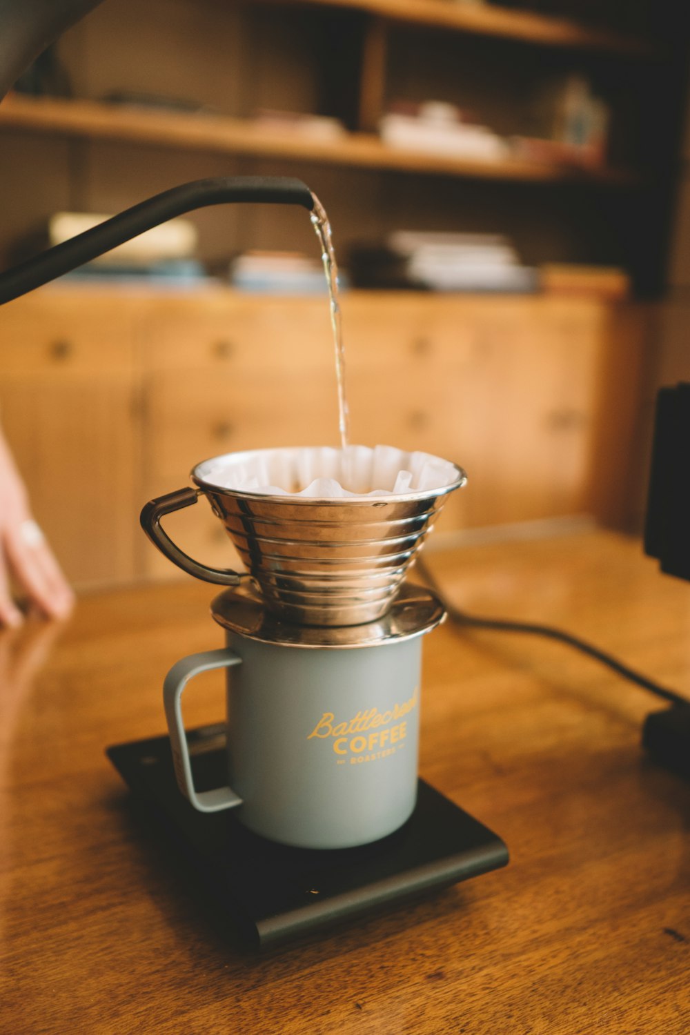 white ceramic mug on black wooden table