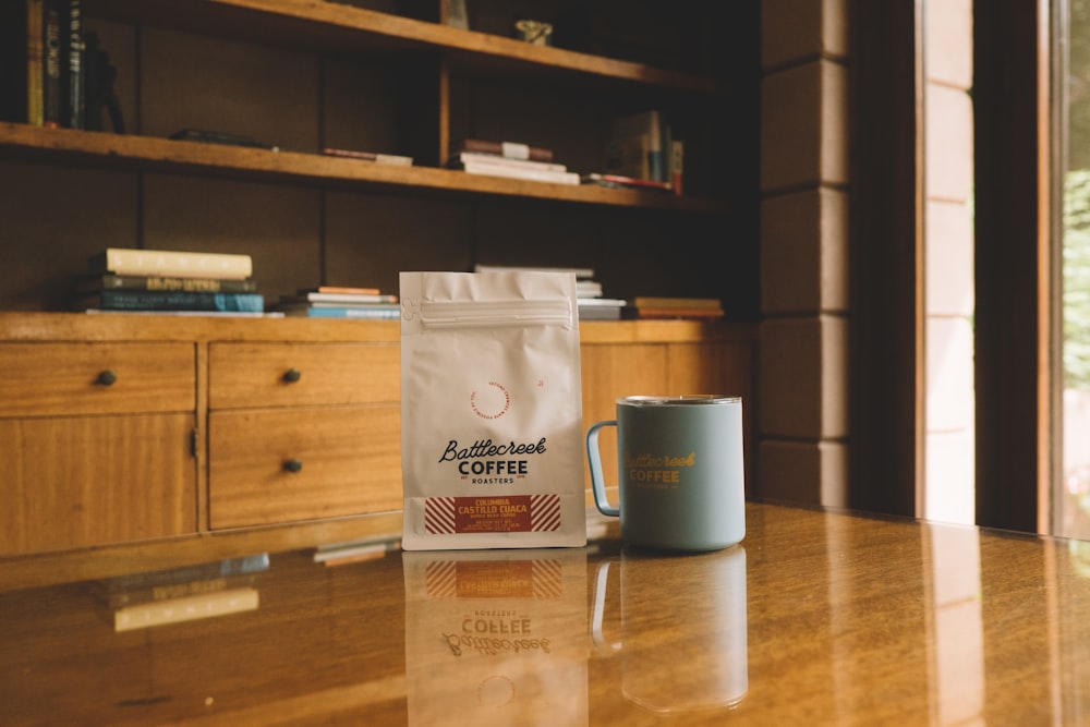 white ceramic mug on brown wooden table