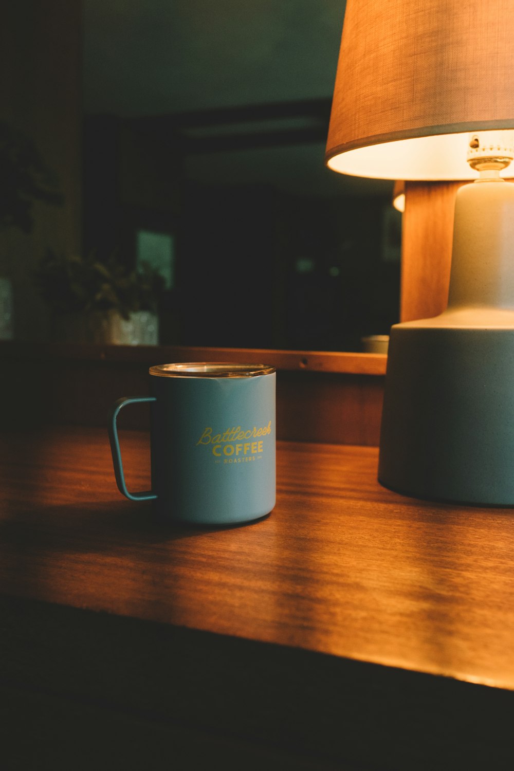 a blue coffee mug sitting on top of a wooden table