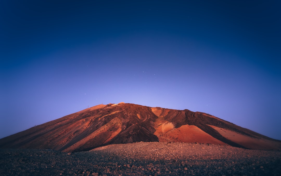 brown mountain under blue sky during daytime