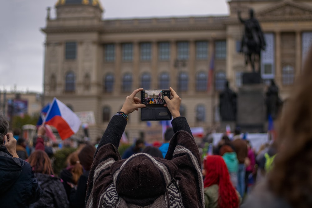 a person taking a picture of a crowd of people