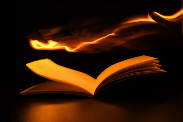 An open book with glowing pages revealing a magical forest and ancient castles.