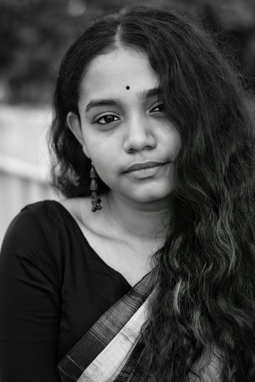 a black and white photo of a woman with long hair