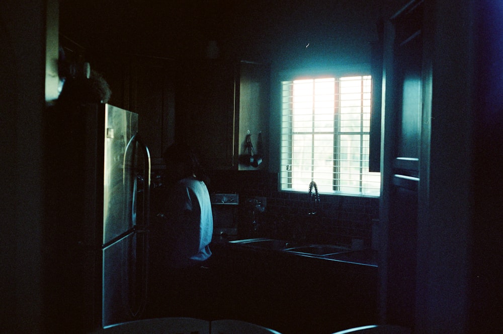 white top mount refrigerator beside white wooden door