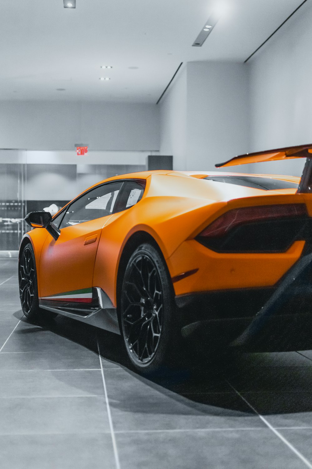 orange lamborghini aventador parked inside building