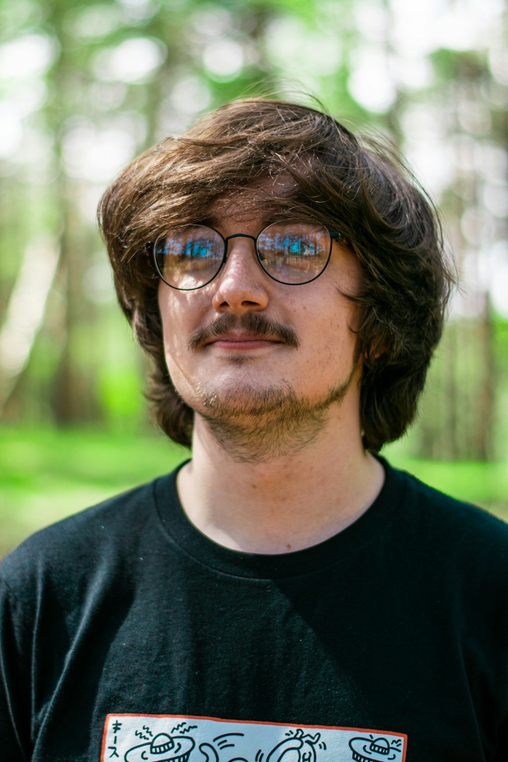 man in black crew neck shirt wearing eyeglasses