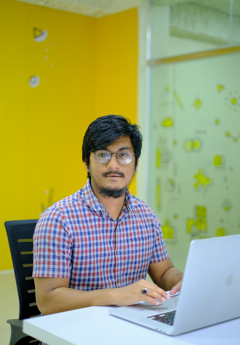 a man sitting in front of a laptop computer