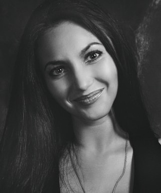 A welcoming image of a woman smiling, symbolizing open communication.