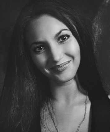 Portrait of Dr. Alice Lang Silva in her medical office, smiling warmly.