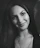 Portrait of a smiling woman sharing a positive customer review.