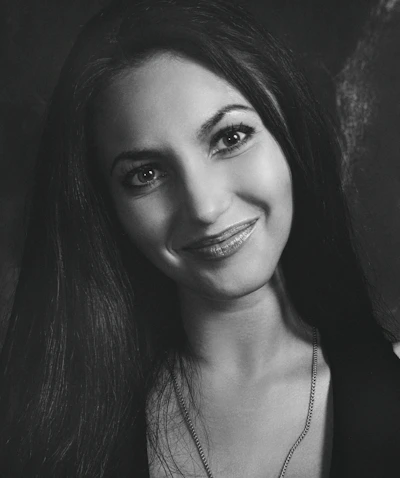 Portrait of Dr. Mariana Ribeiro in her clinic, smiling warmly.