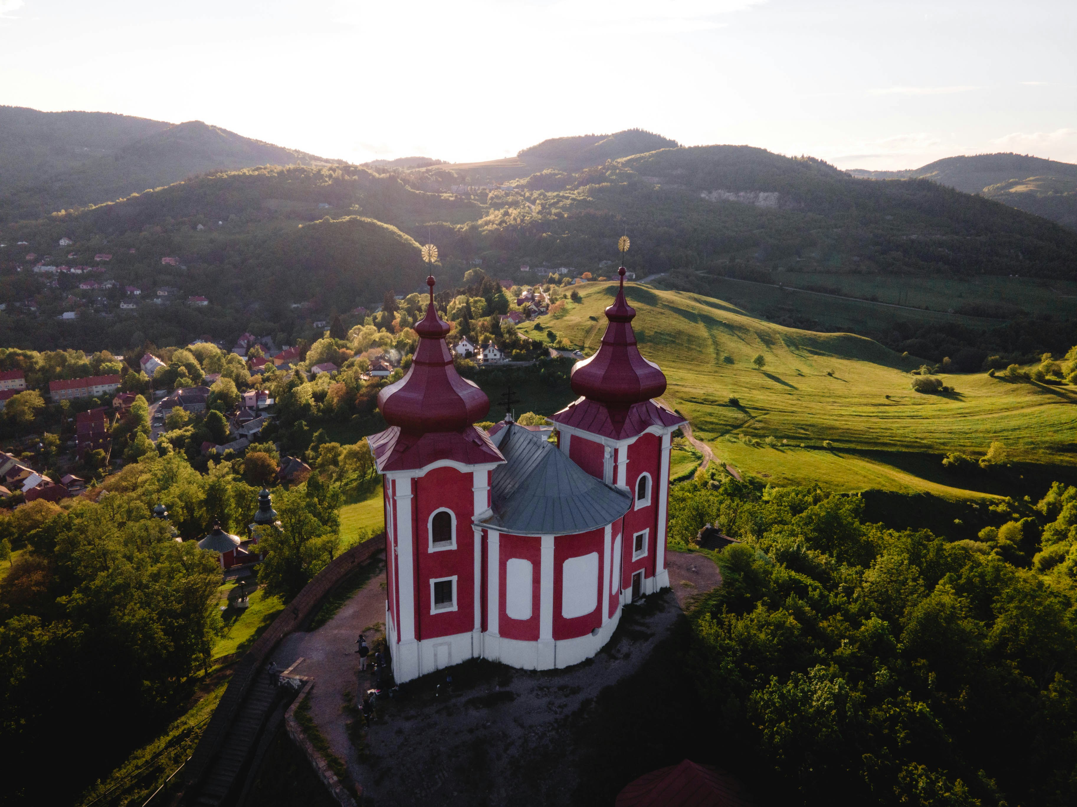 red and white concrete building on hill