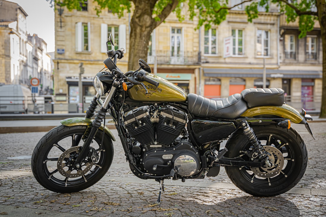 yellow and black cruiser motorcycle parked on brown brick floor during daytime