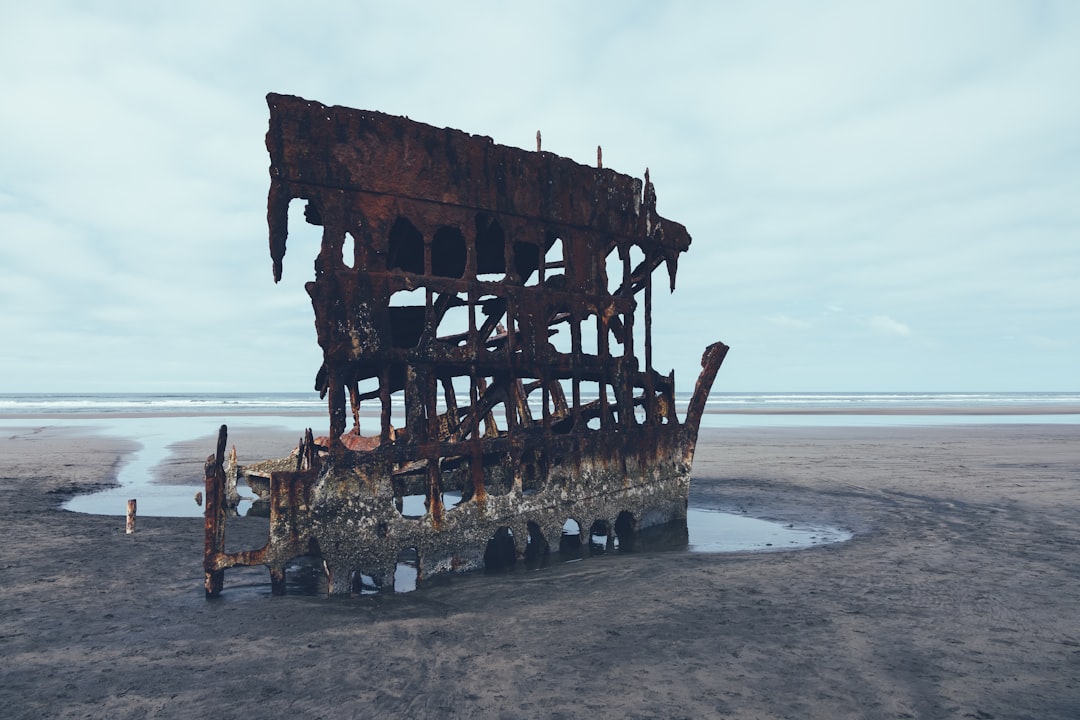 brown wooden ship on sea shore during daytime