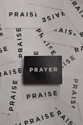 a pile of black and white paper with the word prayer on it