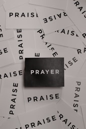 a pile of black and white paper with the word prayer on it