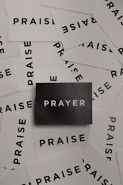 a pile of black and white paper with the word prayer on it