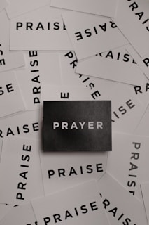 a pile of black and white paper with the word prayer on it