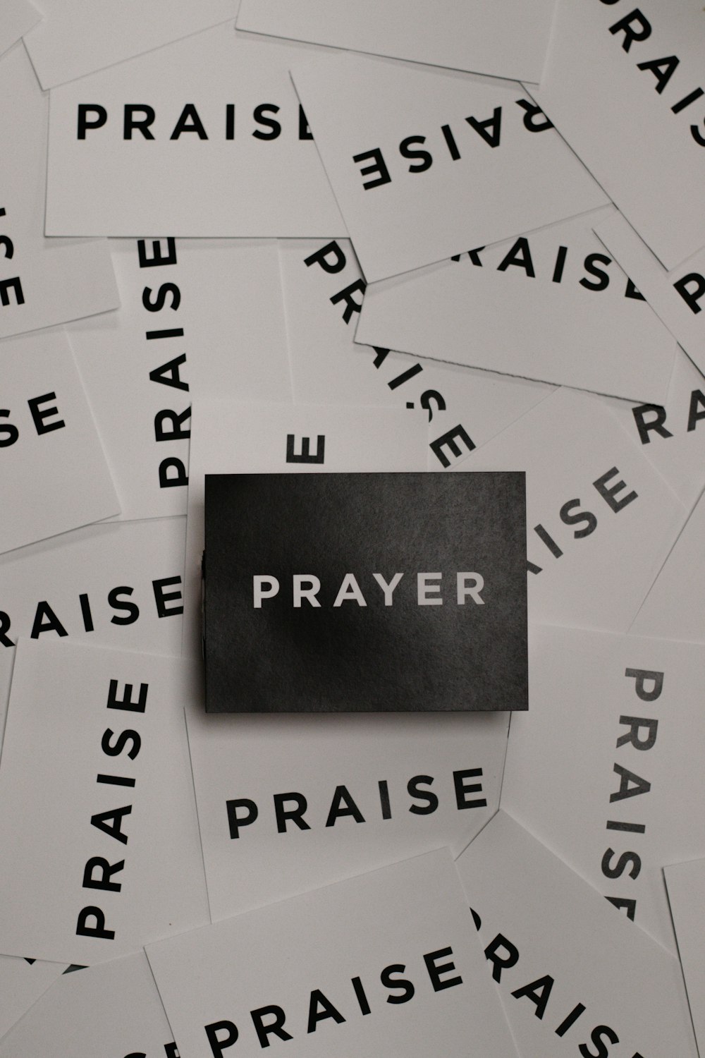 a pile of black and white paper with the word prayer on it