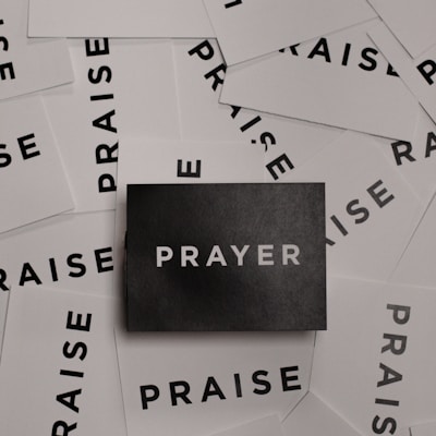 a pile of black and white paper with the word prayer on it