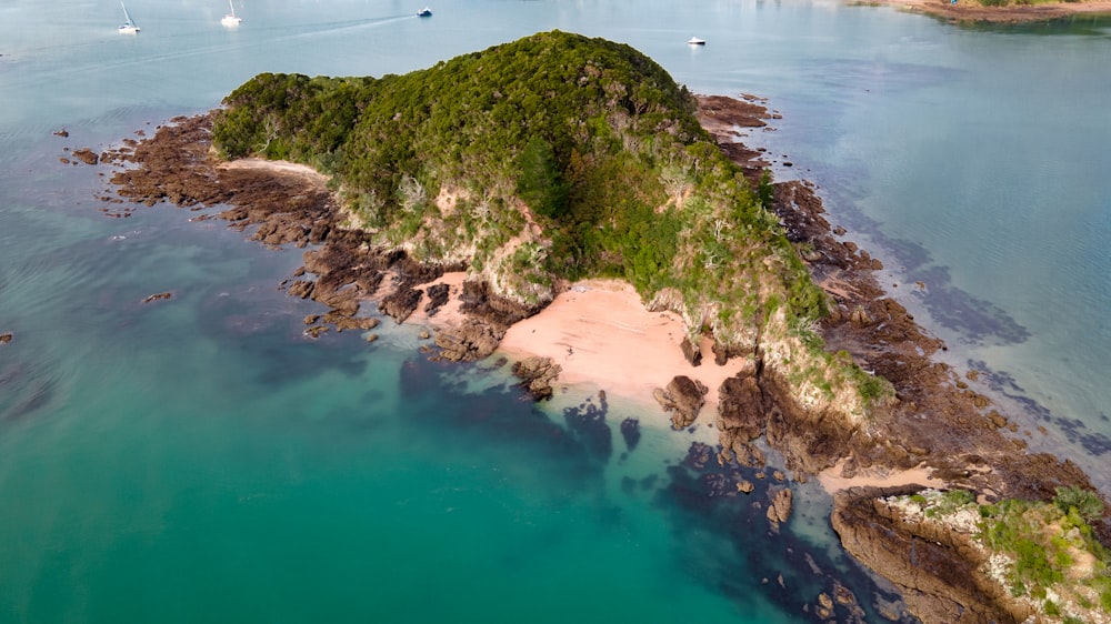 green and brown mountain beside body of water during daytime