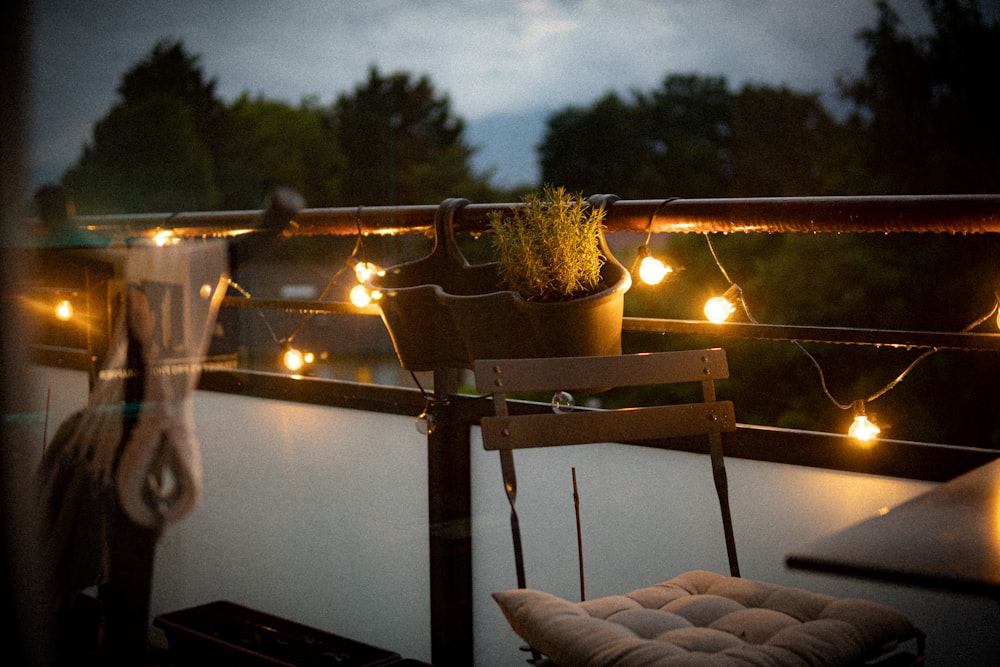 a balcony with a chair and a potted plant on it