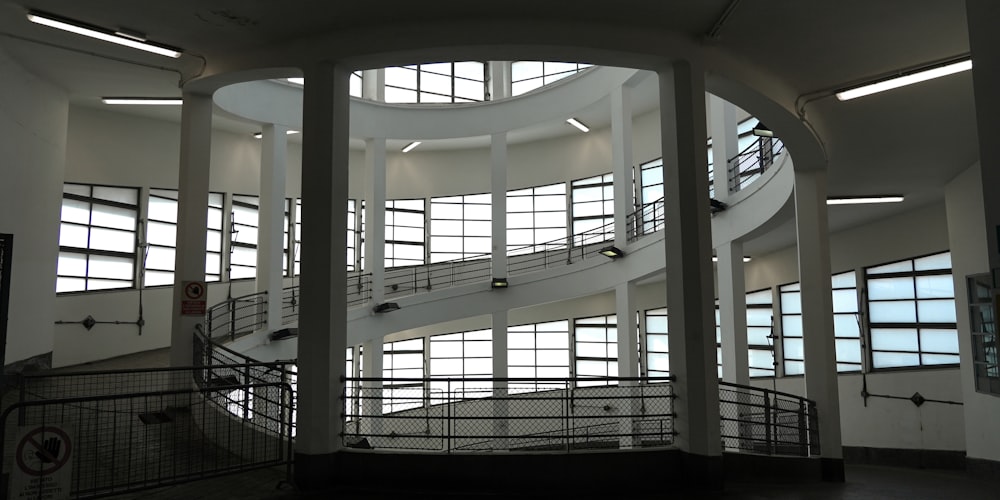 a spiral staircase in a large building with lots of windows