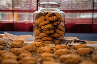 Cozy kitchen scene with a jar of freshly baked cookies and a handwritten note.