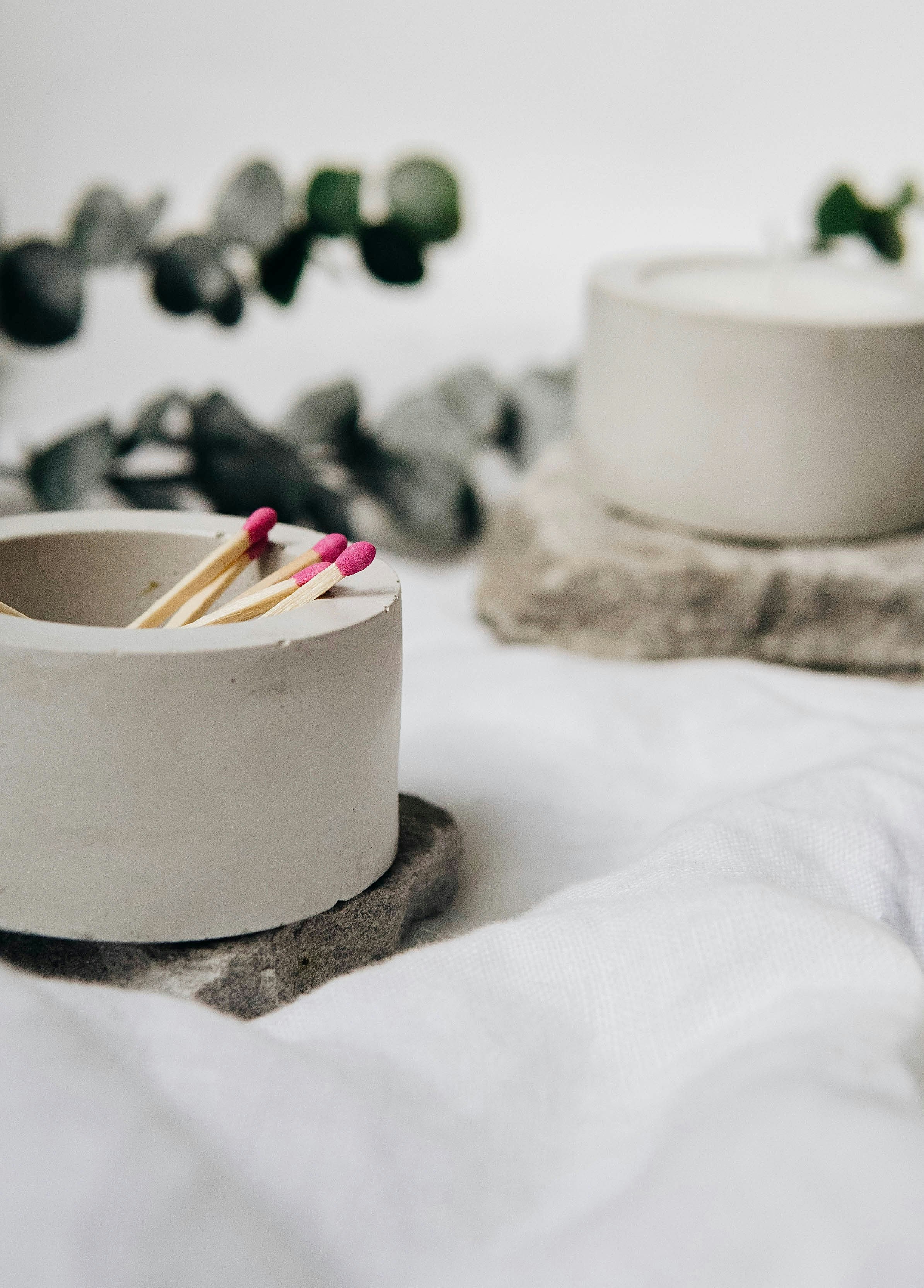 white round ceramic bowl with white and red candles