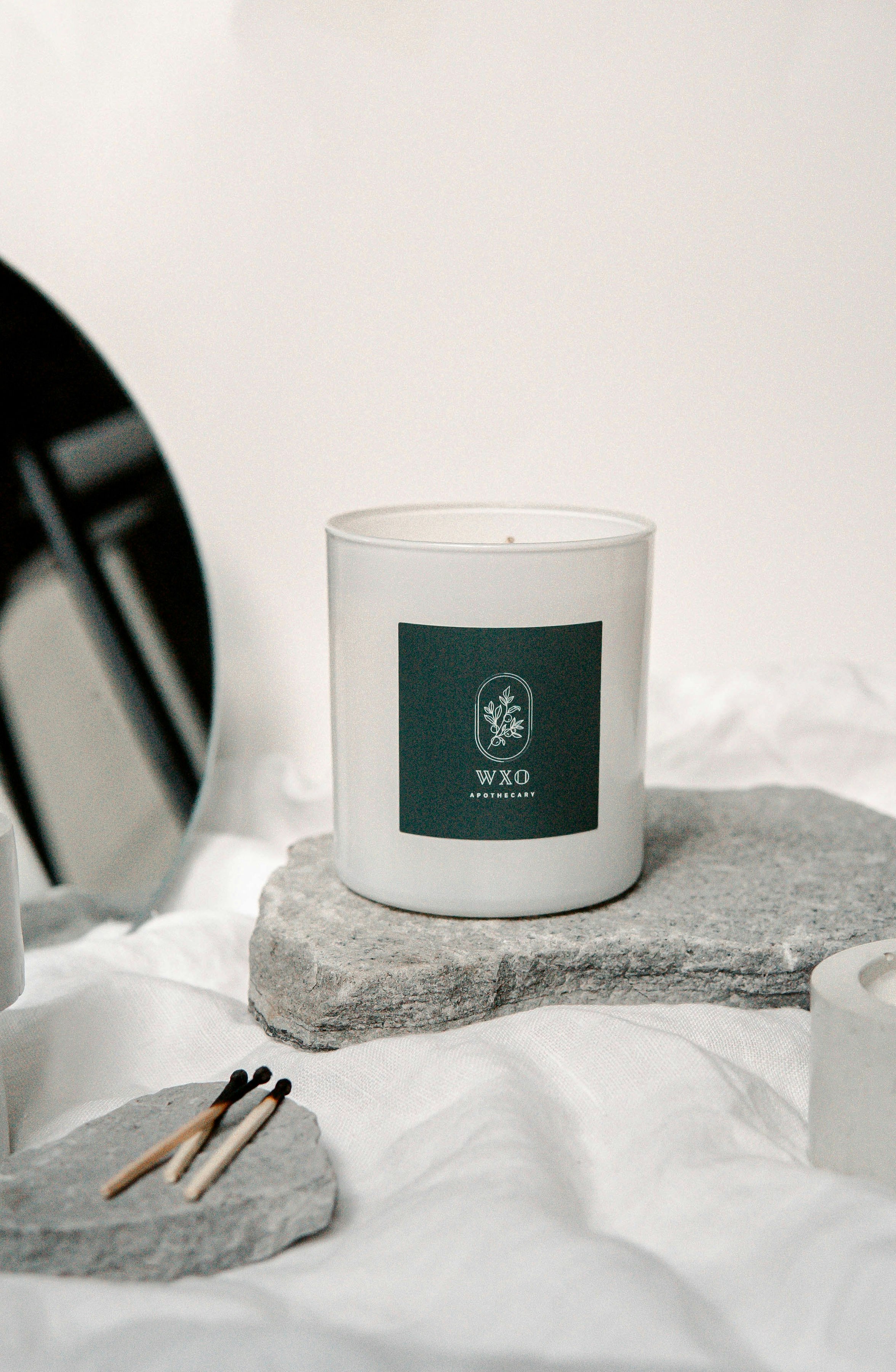 white and black ceramic mug on white table