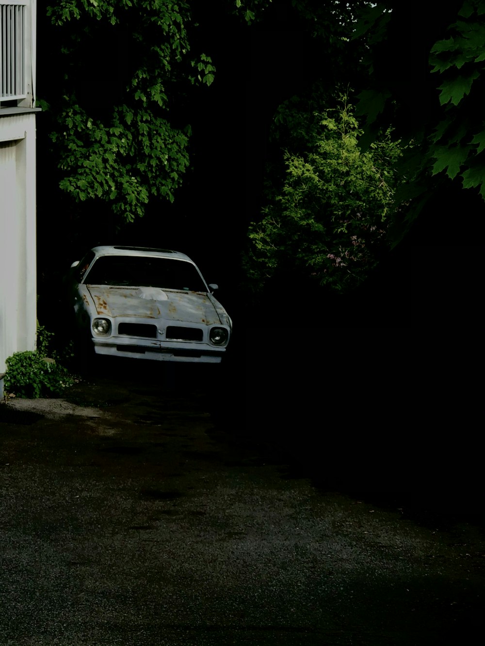 white bmw m 3 parked beside white concrete building