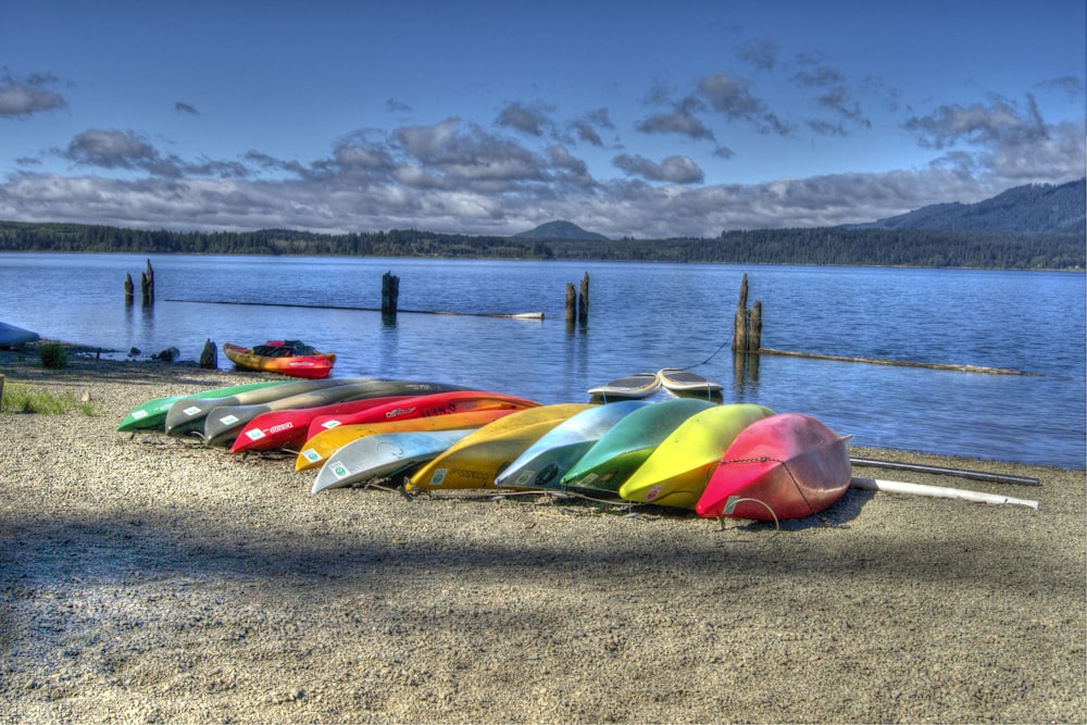 a row of colorful boats sitting on top of a beach