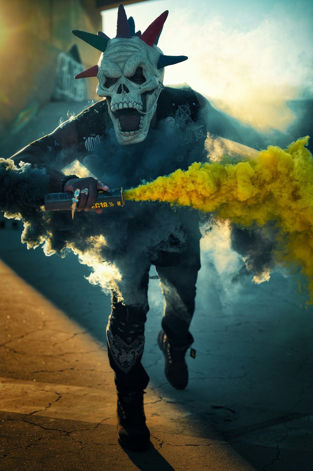 man in black and white mask holding black and yellow power tool