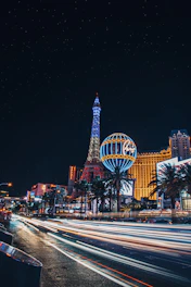 the las vegas strip at night with the eiffel tower in the background