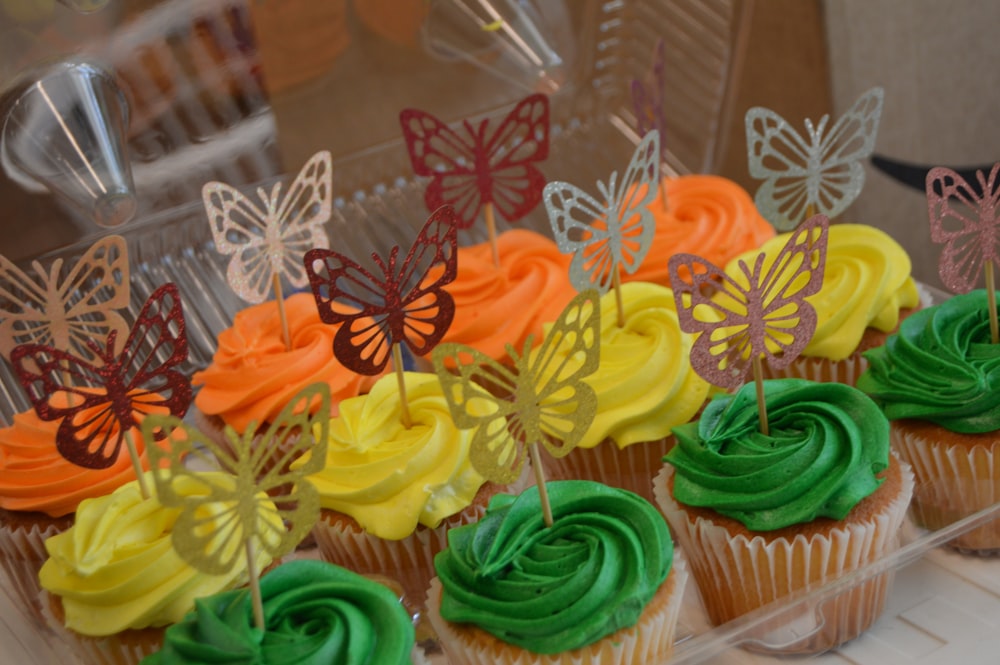 cupcakes with colorful frosting and butterflies on them