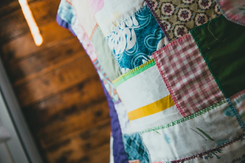 Close-up of colorful embroidered patches arranged neatly on a wooden table.