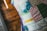 A close-up view of a colorful patchwork quilt displaying various patterns and textures. The quilt consists of squares with different designs, including floral, gingham, and geometric patterns, stitched together with vibrant threads.