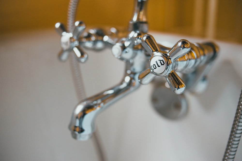 silver faucet with water droplets