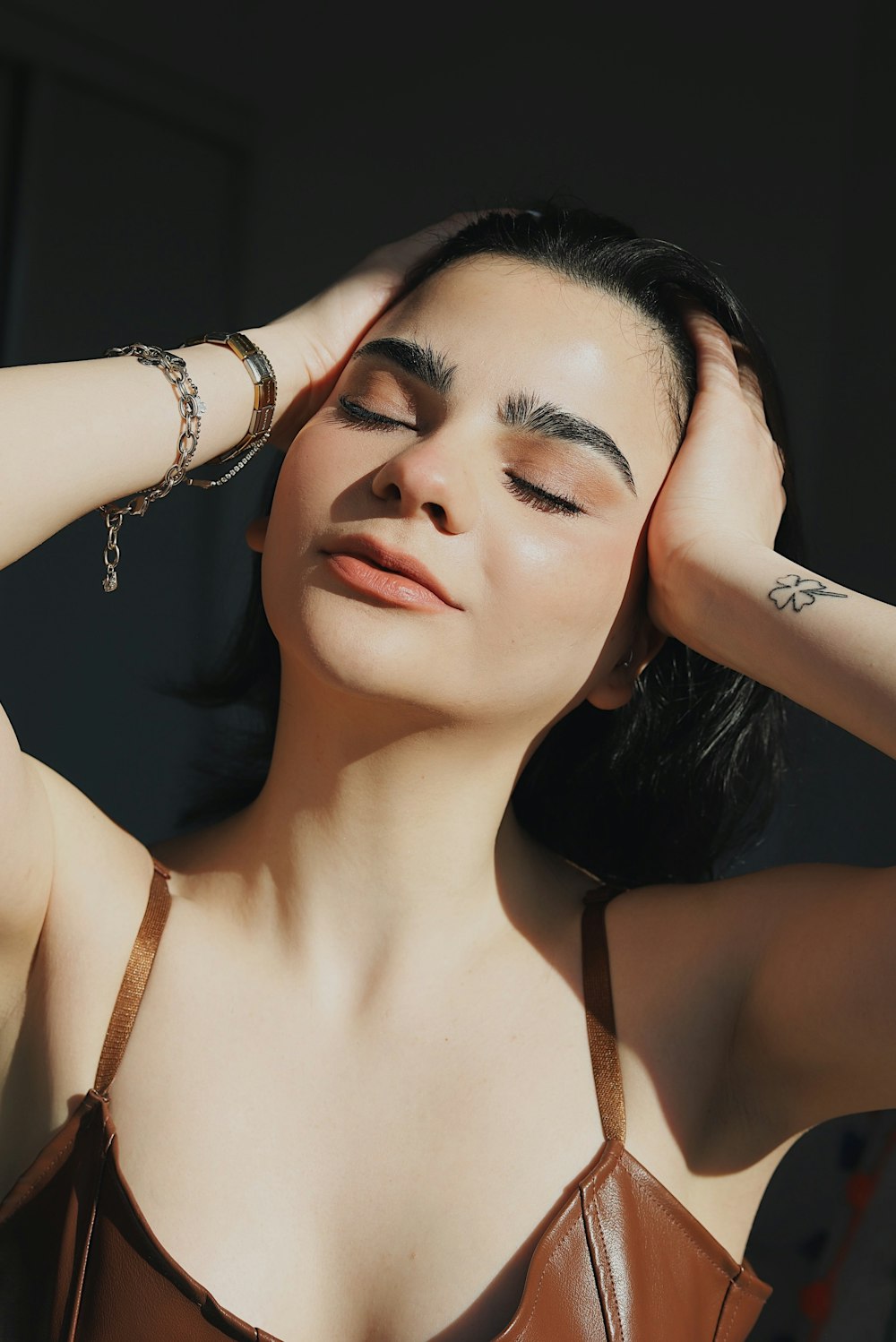 woman in white tank top wearing gold bracelet