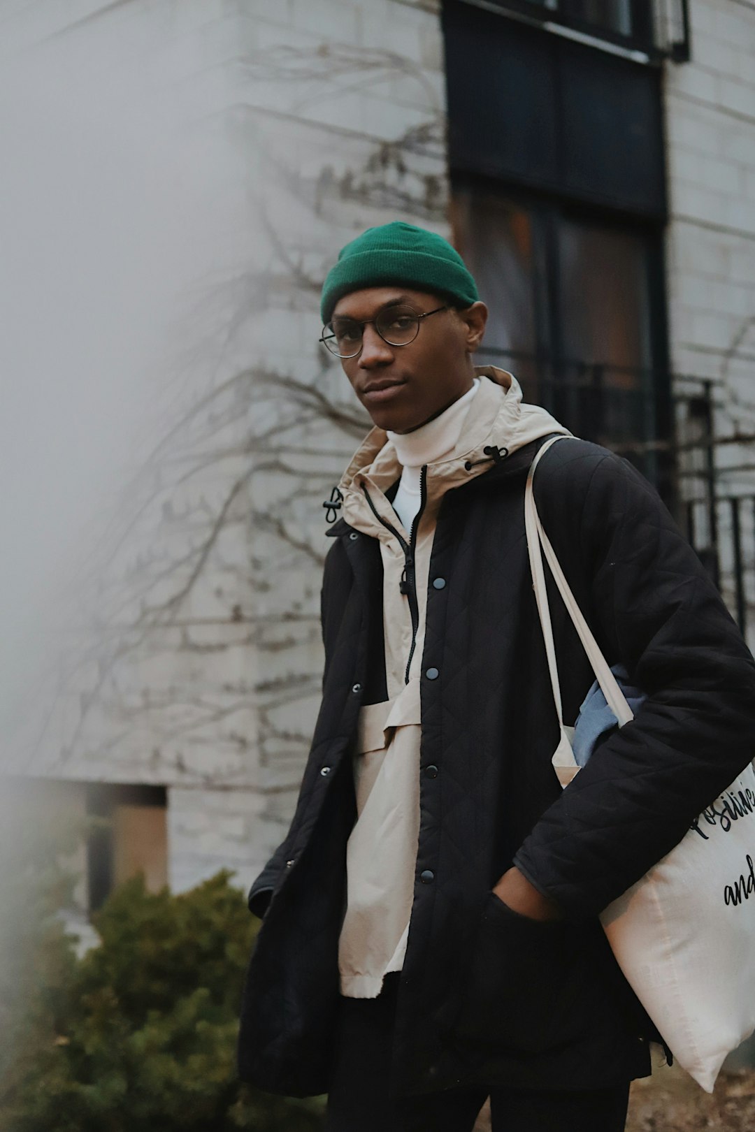 man in black jacket and blue knit cap